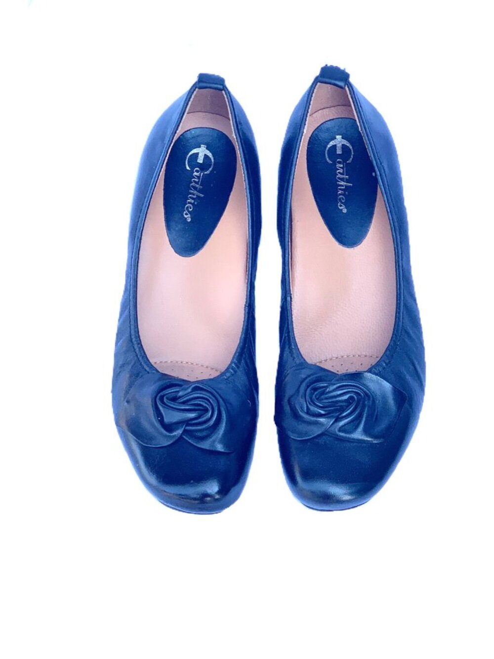 Black leather flats with rose detail.